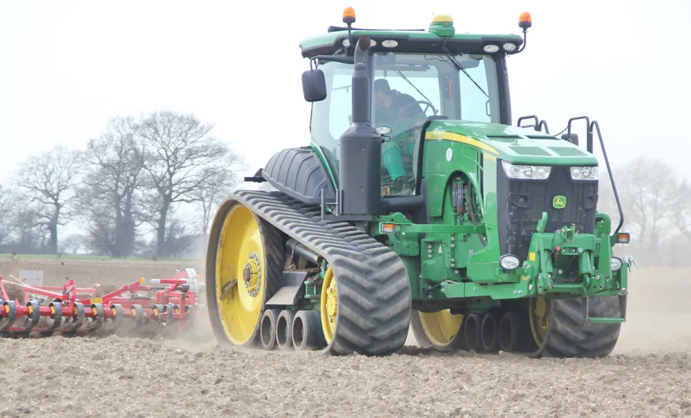 Tractor on rubber tracks working a field